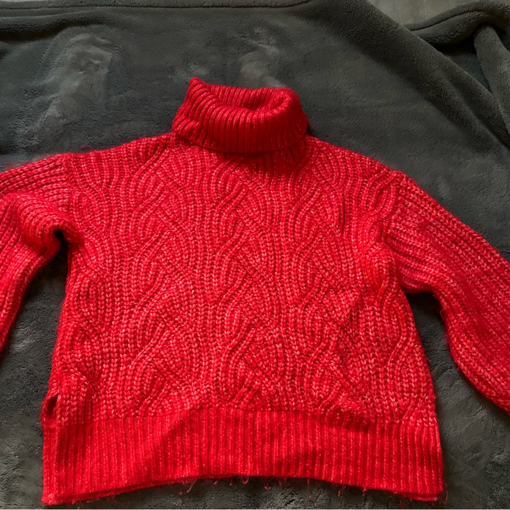 Red “A new day” knitted sweater.